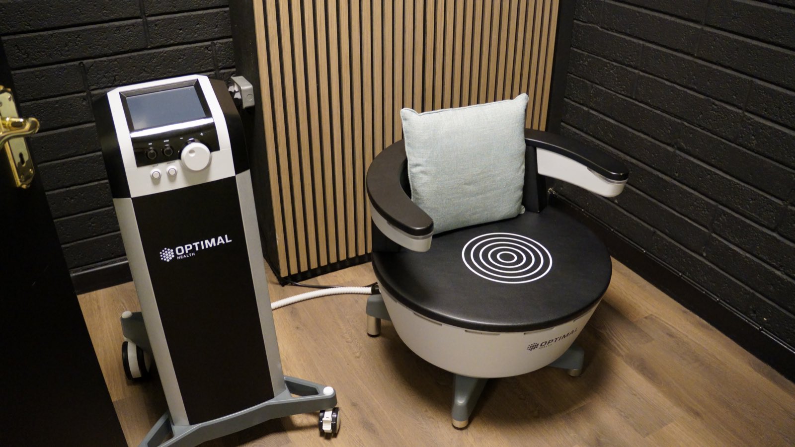 The HIFEM chair and its console, empty, a cushion on the seat