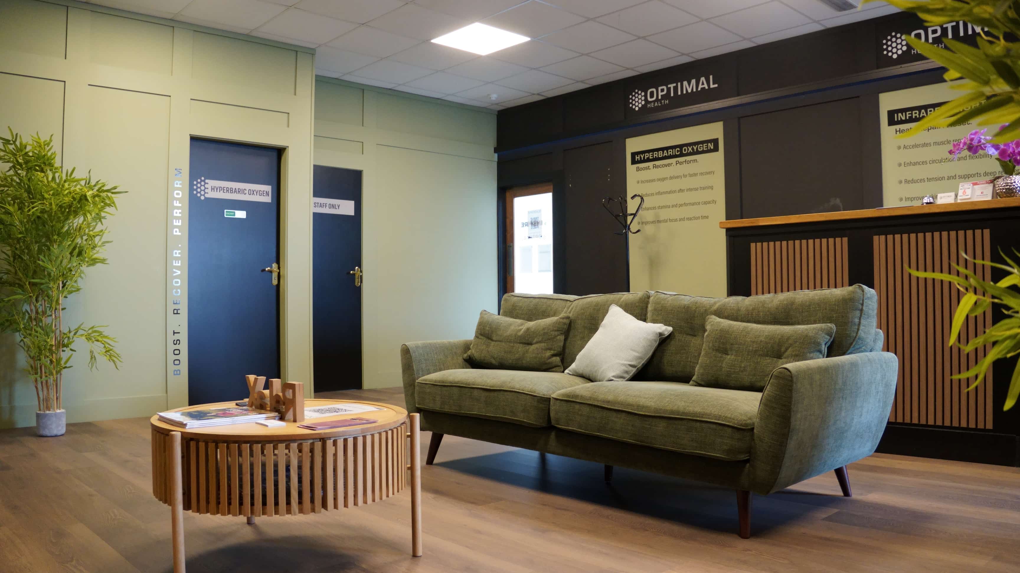 The waiting area at the Clonmel clinic, a low table and bamboo beside the hyperbaric oxygen room door